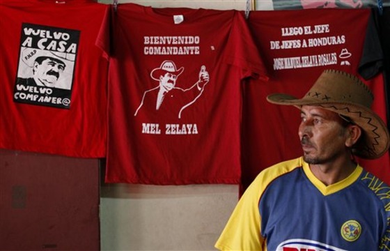 A vendor displays T-shirts with images of Honduras' ousted President Manuel Zelaya in Tegucigalpa, Honduras, Friday May 27, 2011. Supporters are making preparations for the Saturday return of the deposed president who was forced out of the country in his pajamas at gunpoint on June 28, 2009. (AP Photo/Eduardo Verdugo)
